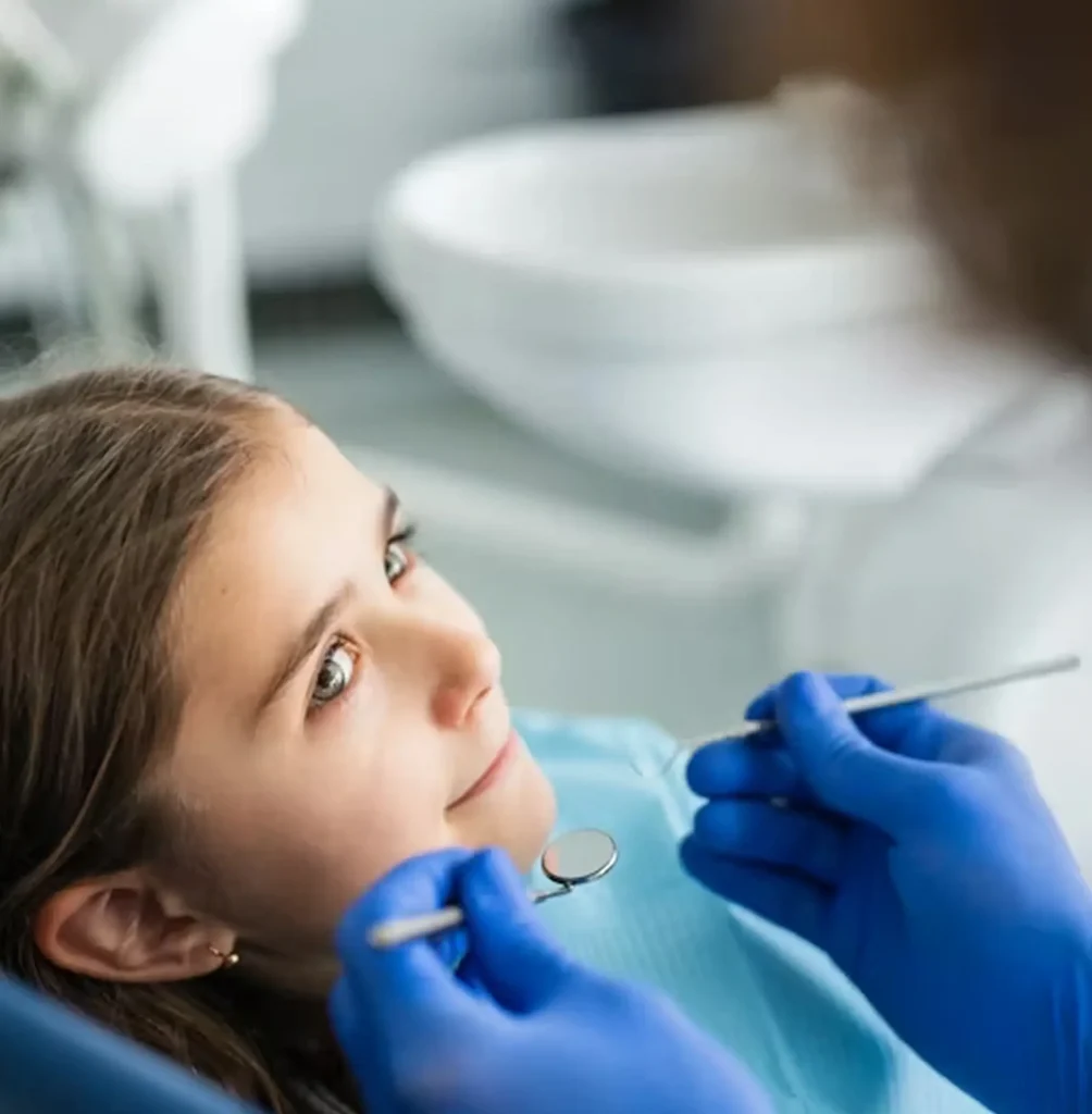 Young girl undergoing a dental check-up with a dentist.