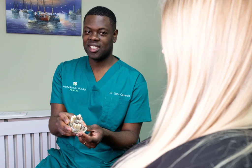 Dentist explaining dental models to a patient in a dental clinic.
