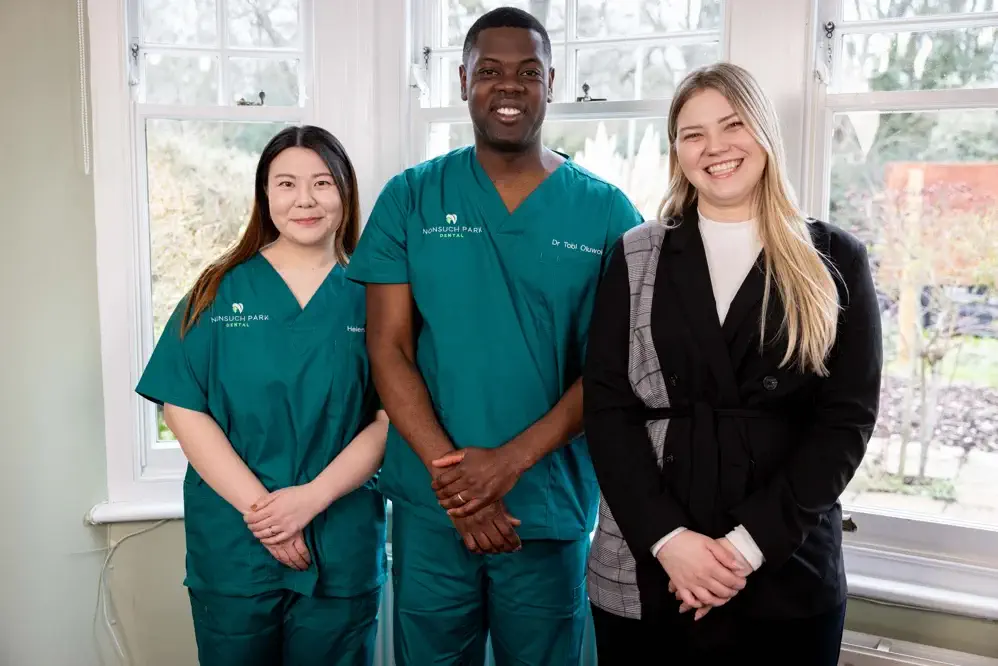 A dental team from Nonsuch Park Dental posing together in their clinic.